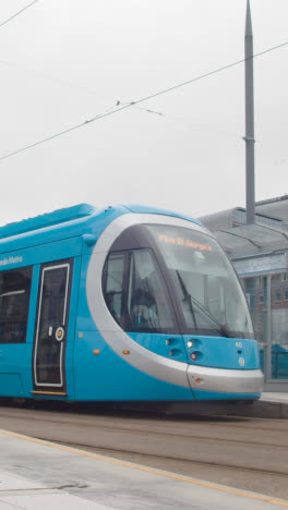 Vertical-Video-Of-Tram-Leaving-Station-Stop-Platform-In-Birmingham-UK-1